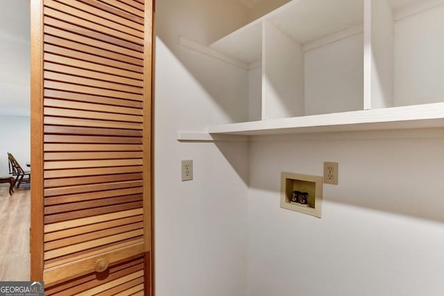 laundry room featuring hookup for a washing machine and light hardwood / wood-style floors