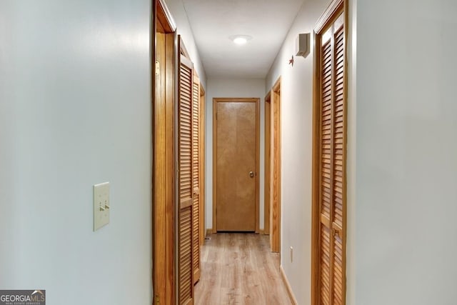 corridor with light wood-type flooring