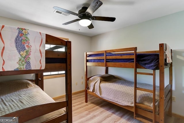 bedroom with light hardwood / wood-style floors and ceiling fan