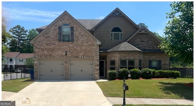 view of front of house featuring a garage and a front lawn