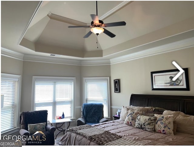 bedroom featuring crown molding, ceiling fan, and a raised ceiling