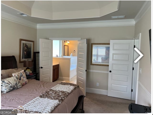 bedroom featuring ornamental molding, light carpet, and a tray ceiling