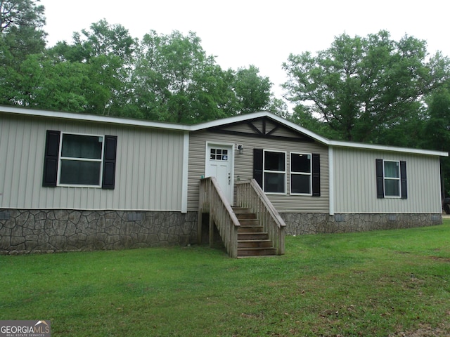 rear view of property featuring a yard