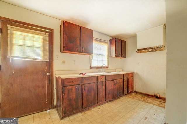 kitchen featuring sink and light tile flooring