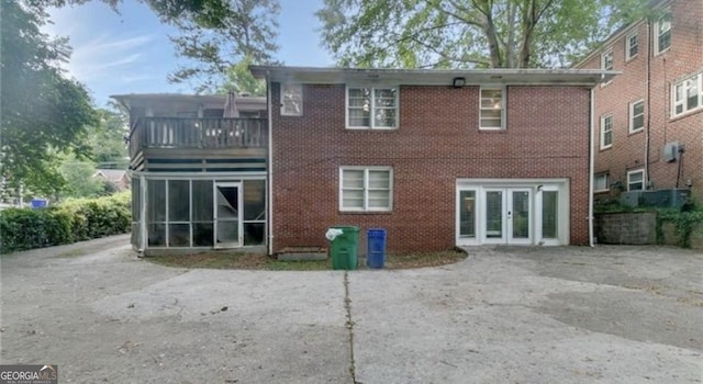 back of house with a balcony and a sunroom