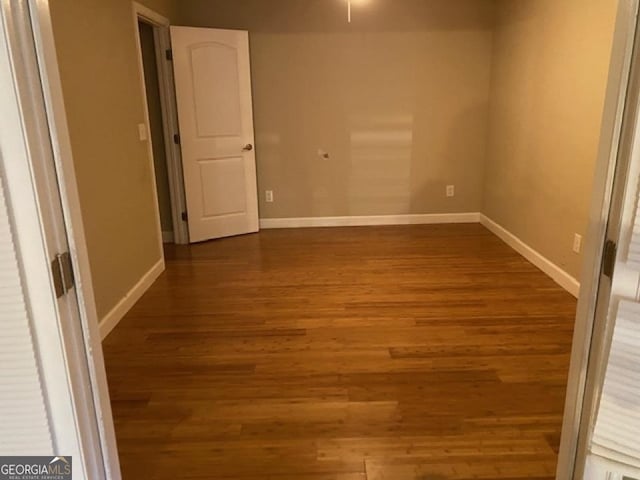 spare room featuring dark hardwood / wood-style floors