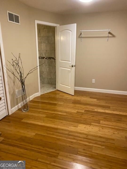 spare room featuring wood-type flooring