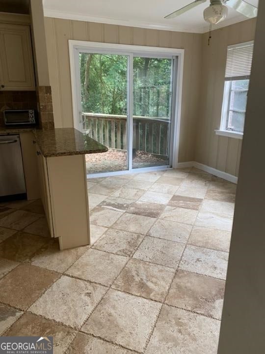 interior space featuring light tile flooring, ceiling fan, dishwasher, and ornamental molding