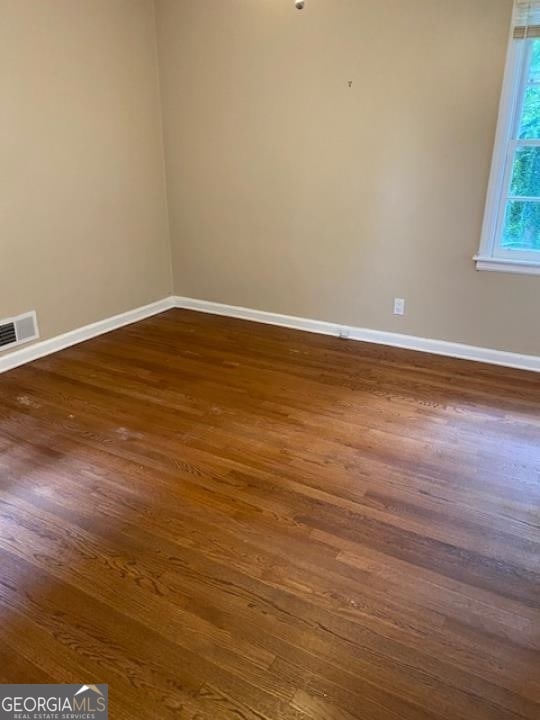 spare room featuring dark hardwood / wood-style floors