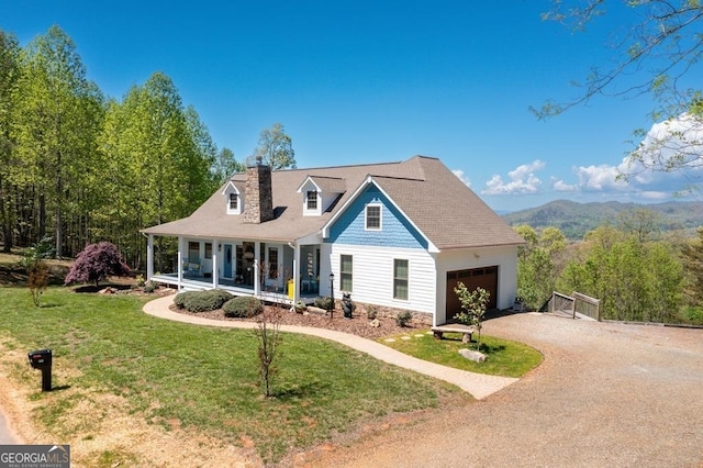 view of front of home featuring a front lawn, a porch, and a garage