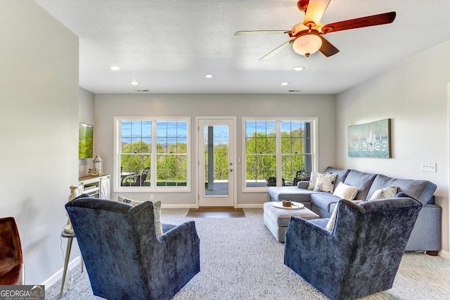 living room featuring light hardwood / wood-style flooring and ceiling fan