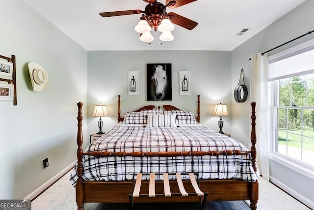 bedroom with carpet flooring, ceiling fan, and multiple windows