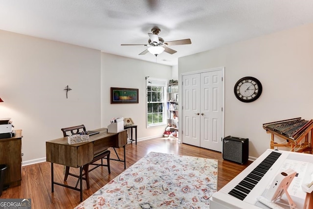 office featuring hardwood / wood-style flooring and ceiling fan