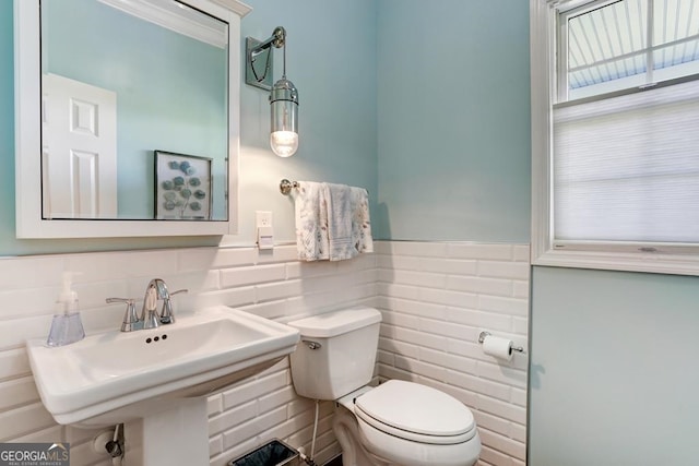 bathroom featuring sink, tile walls, backsplash, and toilet