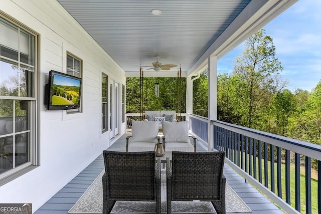 deck featuring ceiling fan and an outdoor hangout area