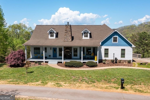 new england style home featuring a porch and a front yard