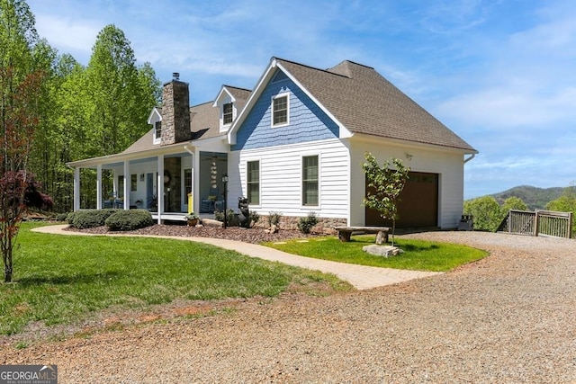 view of front facade with a front lawn, a garage, and a porch