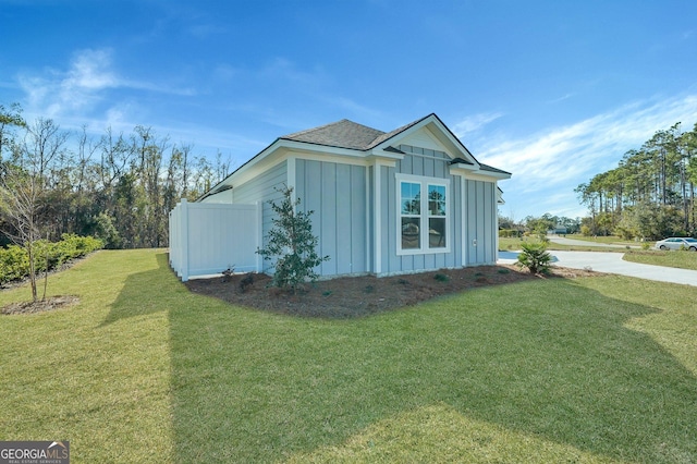 view of side of home featuring a yard