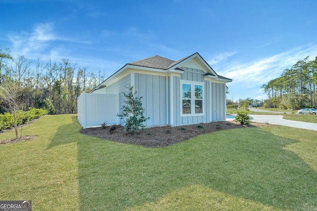 view of side of home featuring a lawn