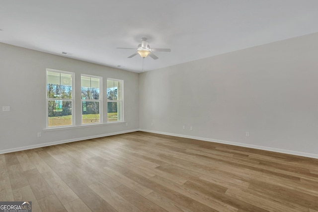 spare room featuring light hardwood / wood-style floors and ceiling fan