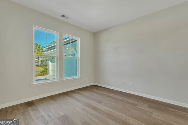 unfurnished room featuring light hardwood / wood-style floors