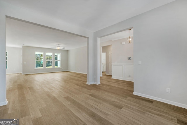 unfurnished living room with ceiling fan and light hardwood / wood-style flooring