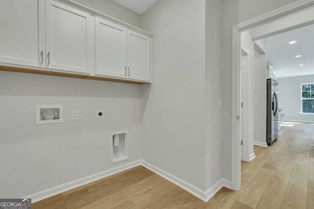 washroom with hookup for a washing machine, electric dryer hookup, cabinets, and light hardwood / wood-style floors