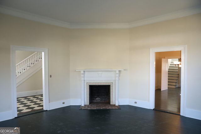 unfurnished living room featuring a fireplace, dark hardwood / wood-style floors, and crown molding