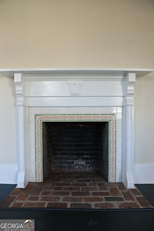 details featuring a tiled fireplace