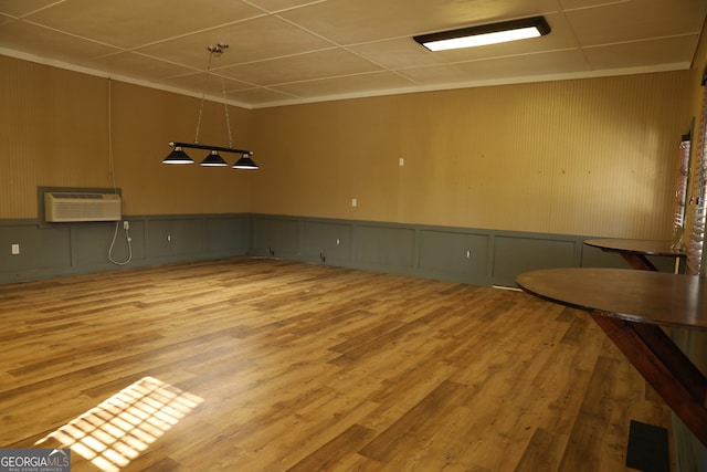 empty room with wood-type flooring and a wall mounted AC