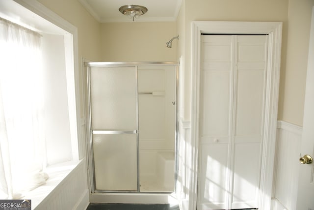 bathroom with crown molding and walk in shower