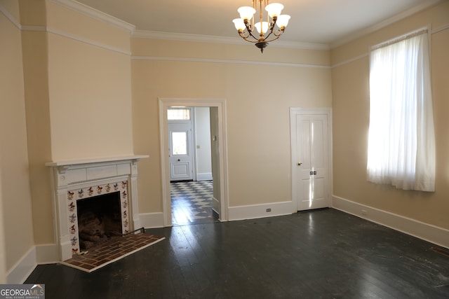 unfurnished living room with dark hardwood / wood-style flooring, a fireplace, ornamental molding, and an inviting chandelier