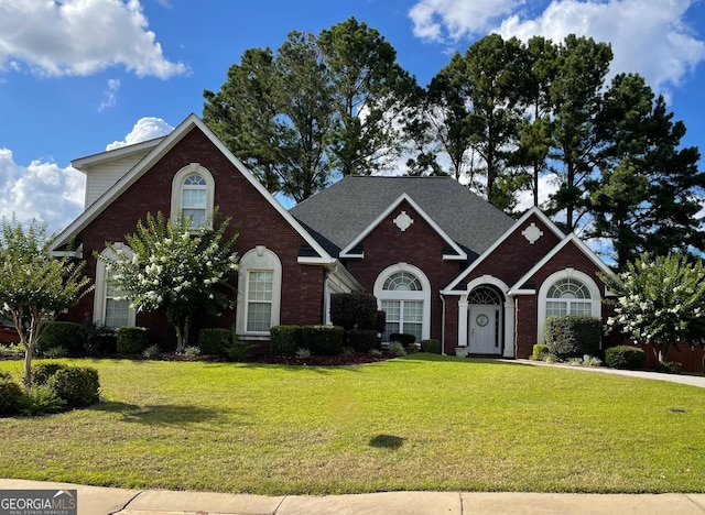 view of property featuring a front lawn