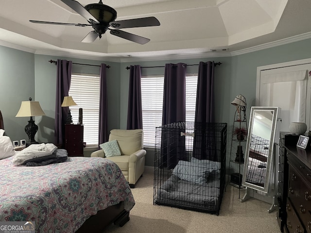 bedroom featuring light carpet, crown molding, and a raised ceiling