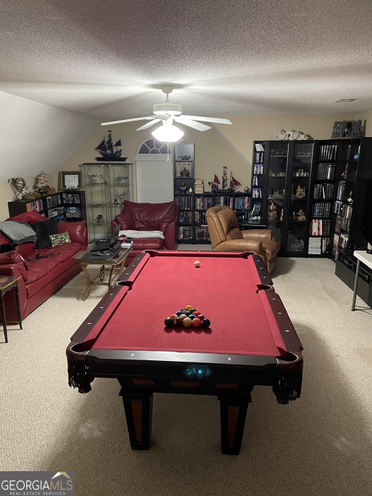 playroom featuring ceiling fan, pool table, a textured ceiling, and carpet flooring