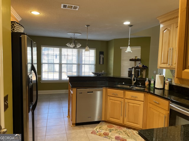 kitchen featuring light tile patterned floors, sink, appliances with stainless steel finishes, hanging light fixtures, and kitchen peninsula