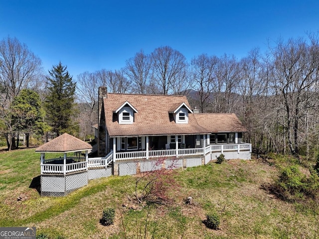 view of front of home featuring a front lawn and a gazebo