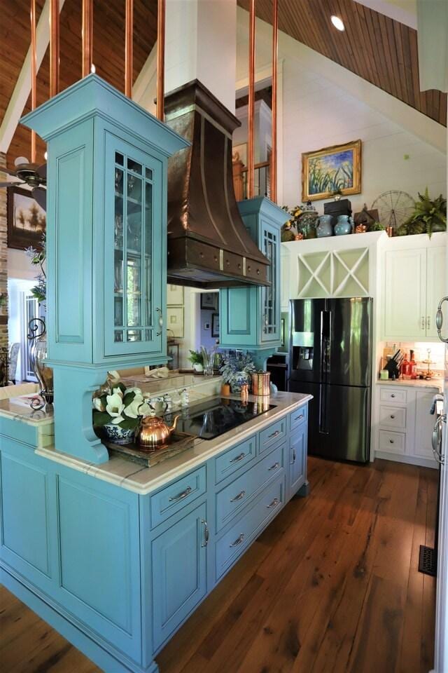 kitchen featuring wood ceiling, dark hardwood / wood-style floors, vaulted ceiling, custom range hood, and black appliances