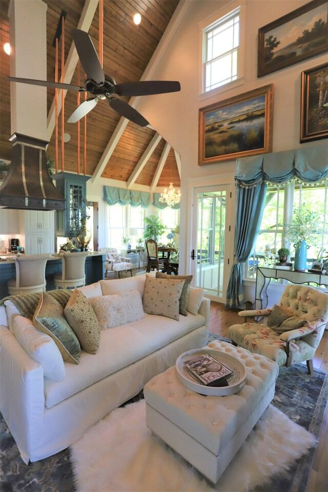 living room featuring wooden ceiling, wood-type flooring, a wealth of natural light, and high vaulted ceiling