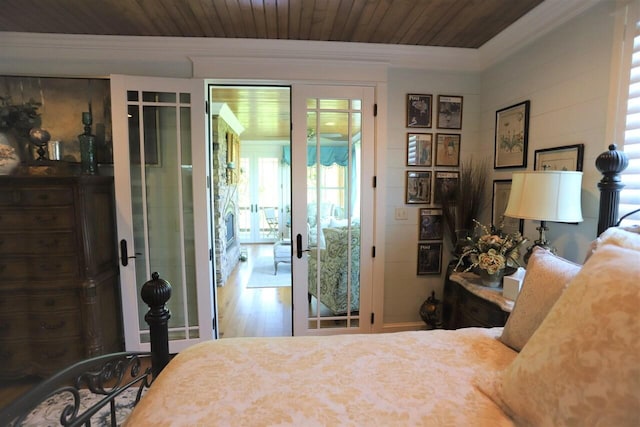 bedroom with ornamental molding, wooden ceiling, hardwood / wood-style flooring, and access to outside