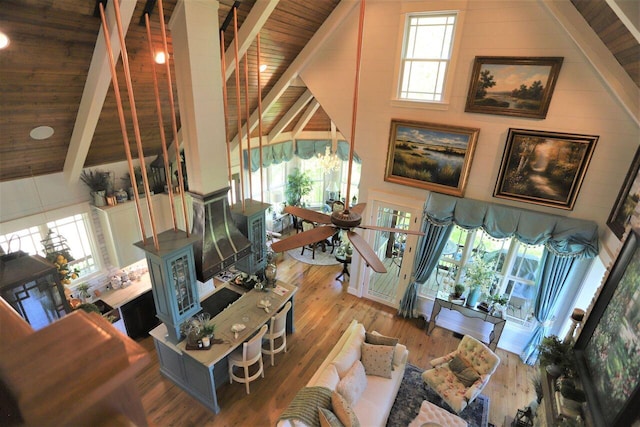 living room with wooden ceiling, beam ceiling, hardwood / wood-style floors, and high vaulted ceiling