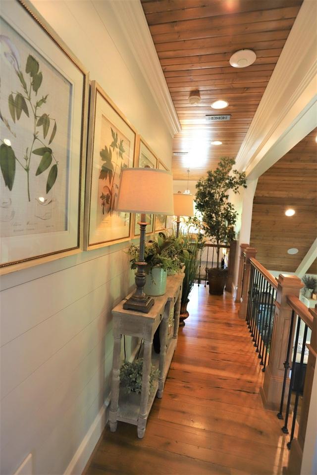 hall featuring wooden ceiling, crown molding, and dark hardwood / wood-style flooring