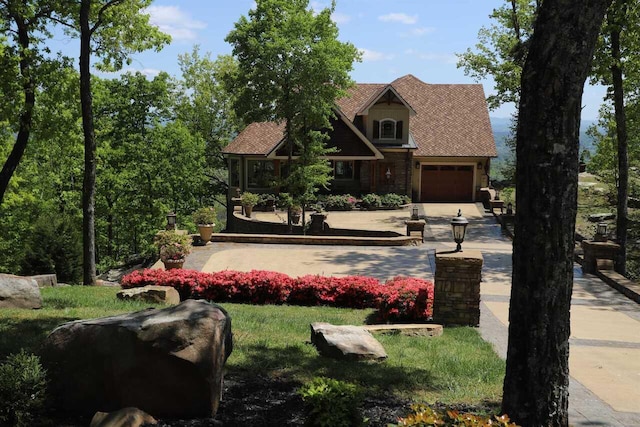 exterior space featuring a front lawn and a garage