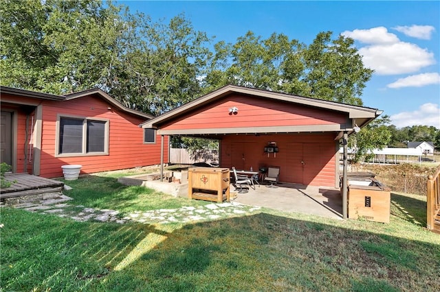 back of house featuring a yard and a patio area