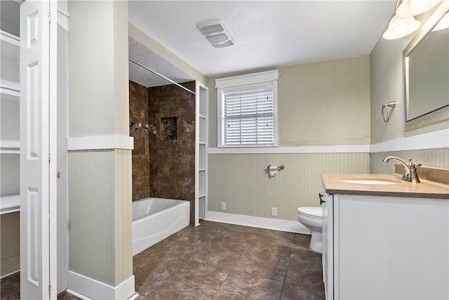 full bathroom featuring vanity, toilet, tiled shower / bath, and wood walls