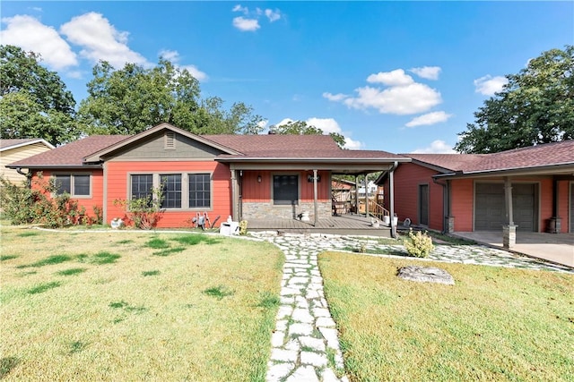 view of front of property with a front yard, a garage, and covered porch