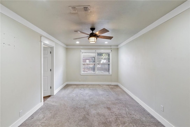 carpeted spare room with ceiling fan and ornamental molding