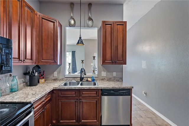 1205 Carolina St, College Station, TX 77840 - kitchen with stainless steel appliances, a sink, baseboards, hanging light fixtures, and light stone countertops