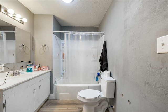 full bathroom featuring vanity, toilet, a textured ceiling, wood-type flooring, and shower / tub combo