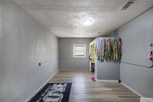 interior space with light hardwood / wood-style floors and a textured ceiling